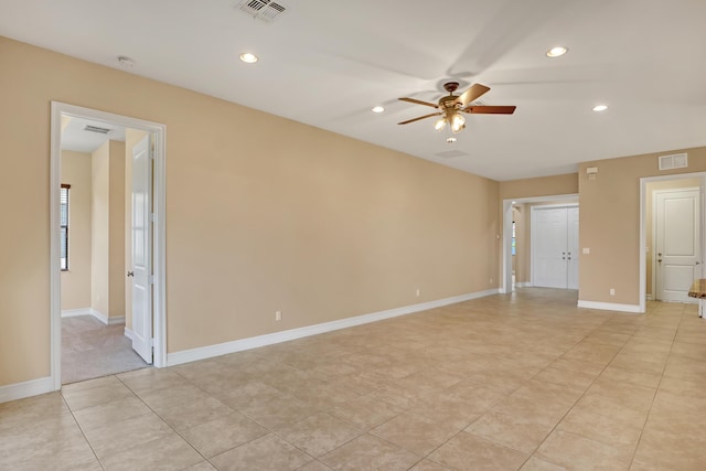 tiled spare room with ceiling fan