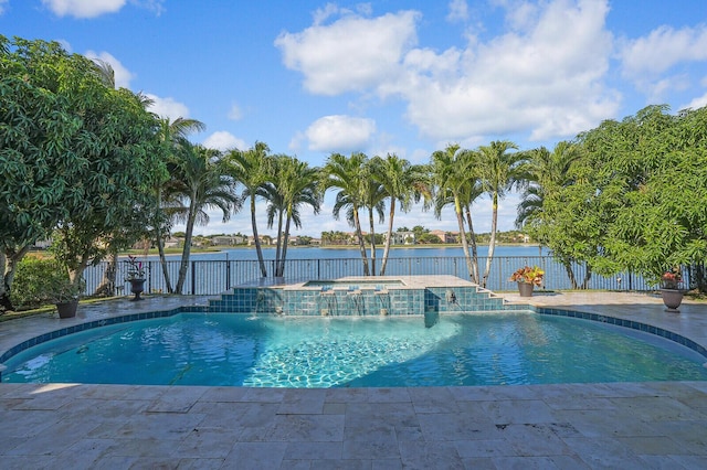 view of swimming pool with a patio, an in ground hot tub, pool water feature, and a water view