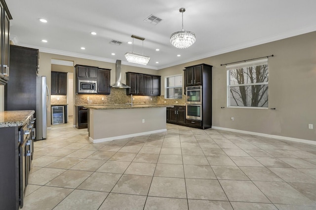 kitchen with decorative light fixtures, stainless steel appliances, crown molding, light stone countertops, and wall chimney exhaust hood