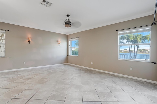 tiled spare room featuring ornamental molding