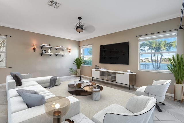 living room featuring ornamental molding and light tile patterned floors