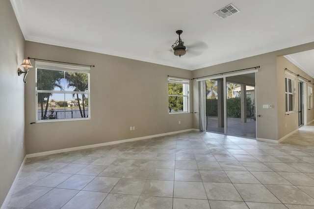 tiled spare room with crown molding and ceiling fan