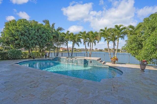 view of pool featuring an in ground hot tub, a water view, pool water feature, and a patio