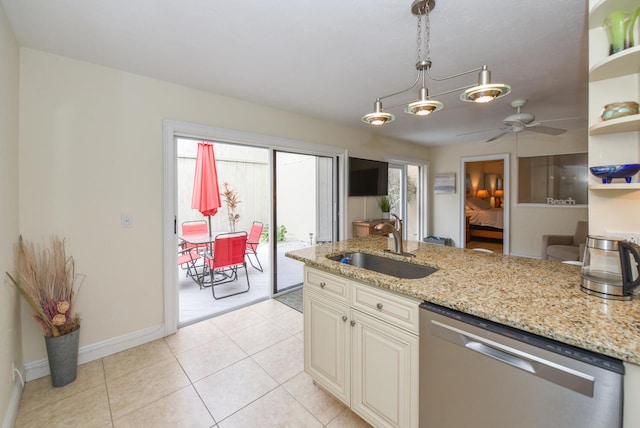 kitchen featuring dishwasher, cream cabinetry, pendant lighting, light stone counters, and sink