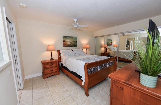 bedroom featuring ceiling fan, a closet, and light tile patterned flooring