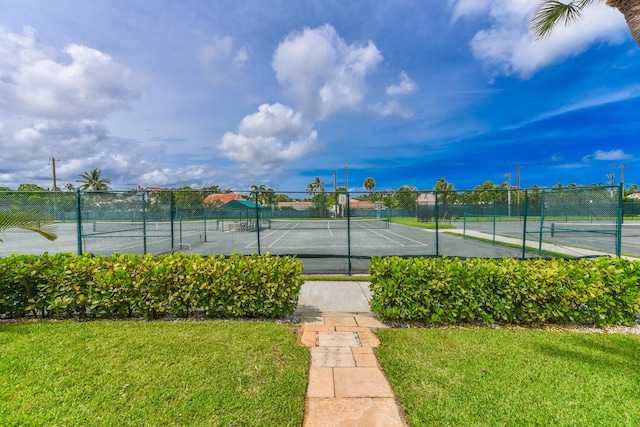 view of sport court with a yard