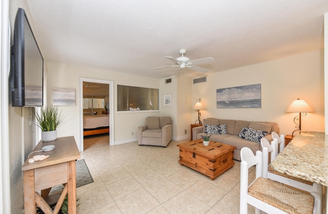 living room with ceiling fan and light tile patterned floors