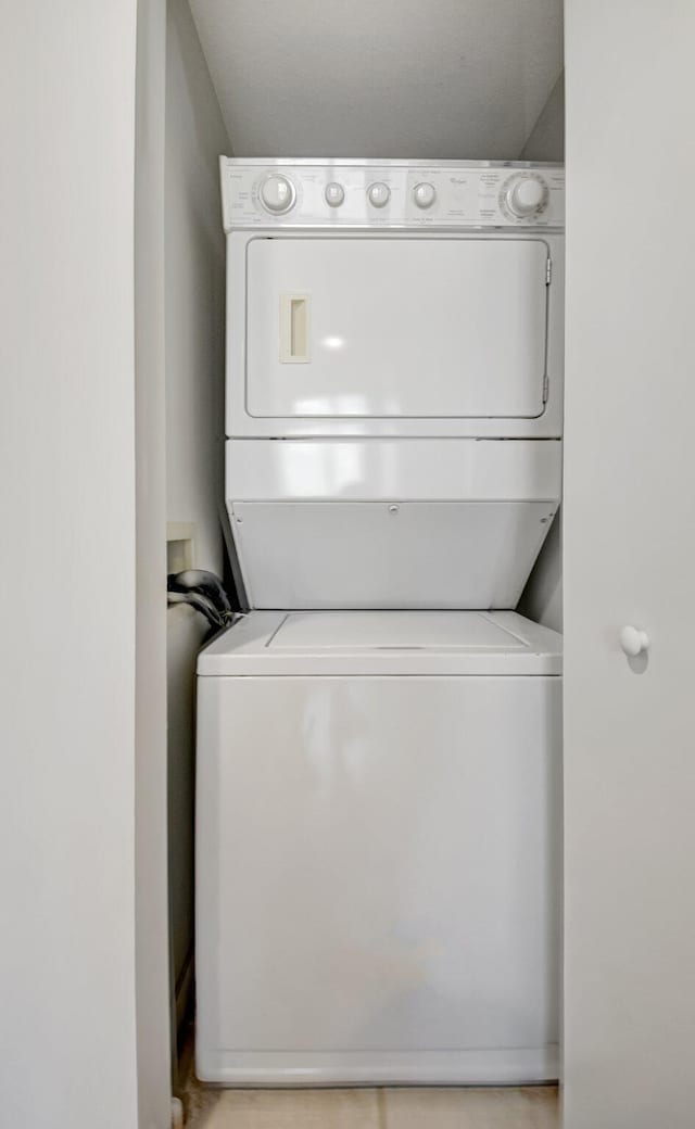 clothes washing area with stacked washer / drying machine