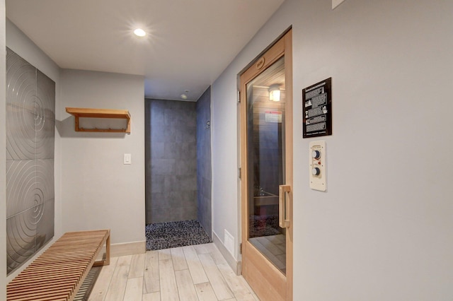 hallway with light hardwood / wood-style flooring