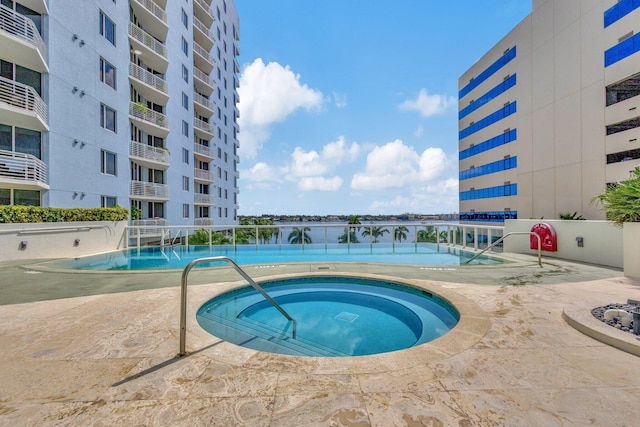 view of pool featuring a community hot tub and pool water feature