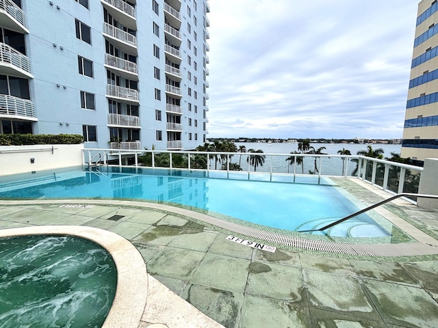 view of swimming pool featuring a water view