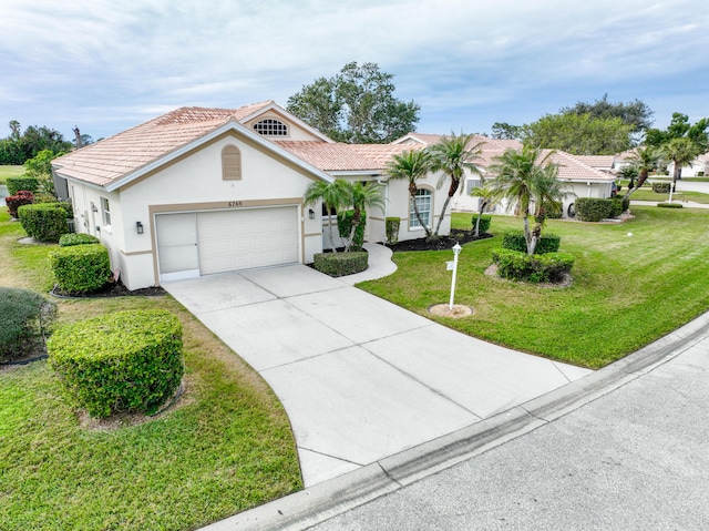 view of front of house featuring a front yard and a garage