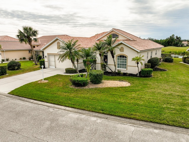 view of front of property featuring a front lawn and a garage