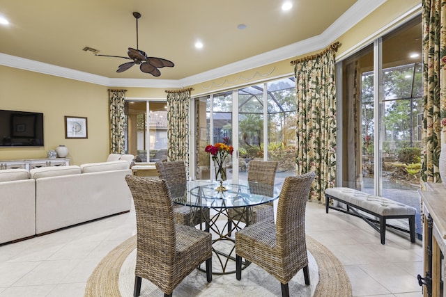 tiled dining room featuring ceiling fan and crown molding