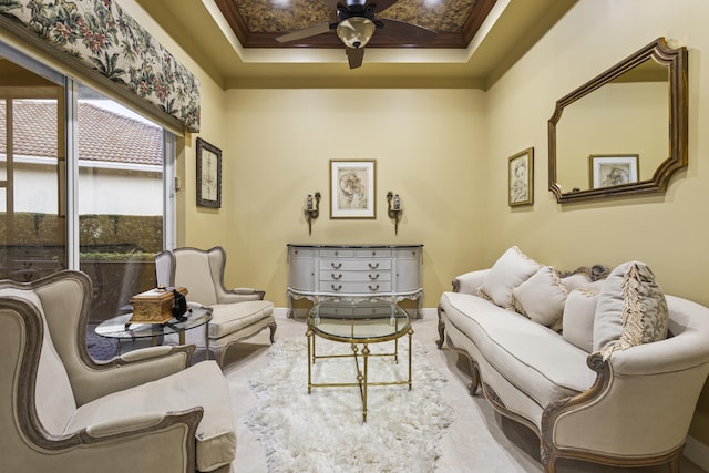 living room with ceiling fan and ornamental molding