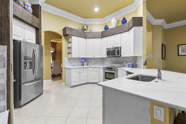 kitchen with sink, white cabinetry, light tile patterned floors, and stainless steel appliances