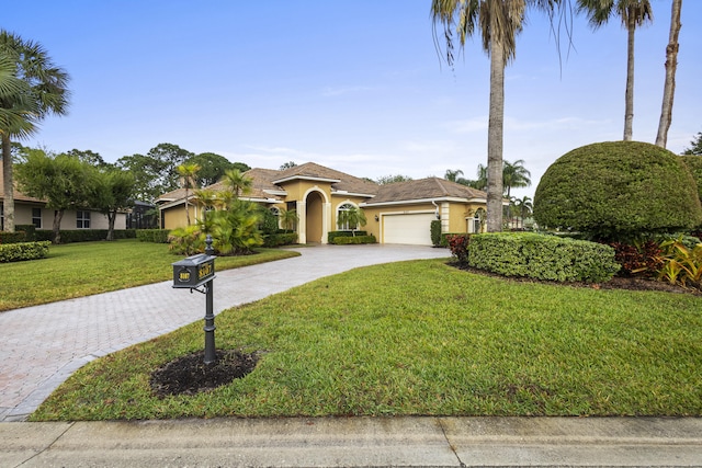 view of front facade featuring a front lawn and a garage