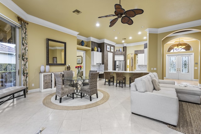 living room with ceiling fan, crown molding, french doors, and light tile patterned flooring