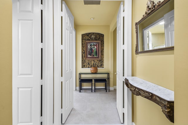 hall featuring light tile patterned floors