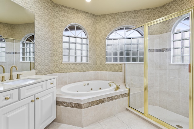 bathroom with plus walk in shower, vanity, and tile patterned flooring