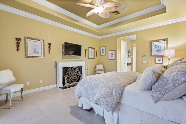 bedroom with ceiling fan, light tile patterned floors, ornamental molding, and a raised ceiling