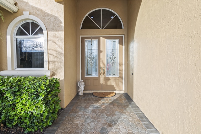 view of exterior entry featuring french doors