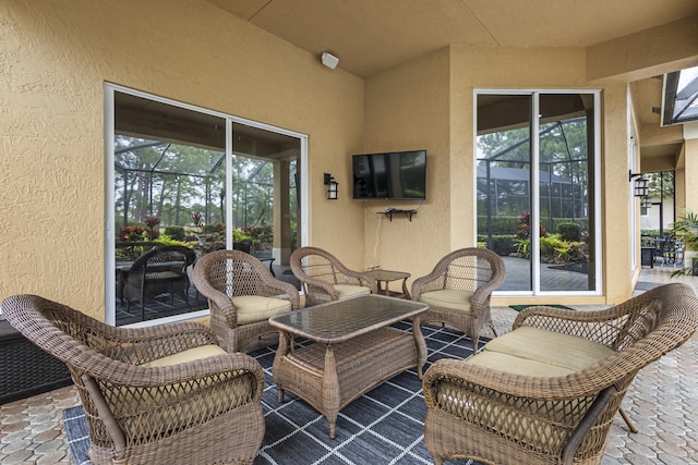 view of patio with glass enclosure and an outdoor hangout area