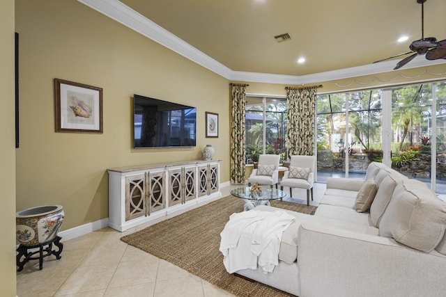 tiled living room with ceiling fan and crown molding