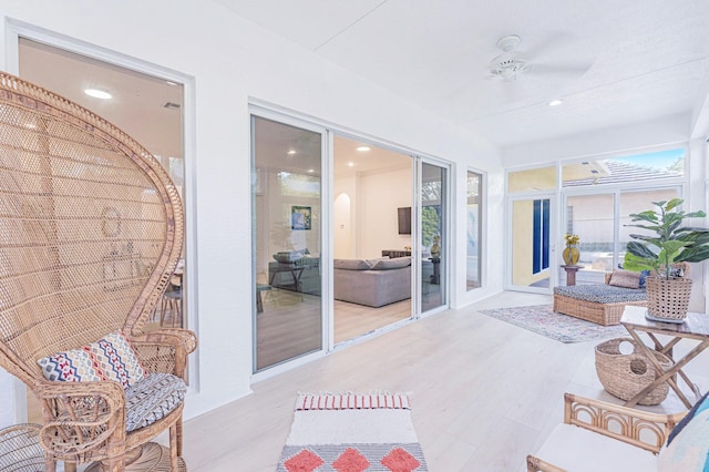 sunroom / solarium featuring ceiling fan