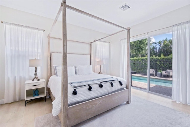 bedroom featuring light wood-type flooring and access to outside