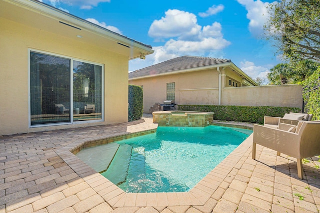 view of pool featuring an in ground hot tub and a patio