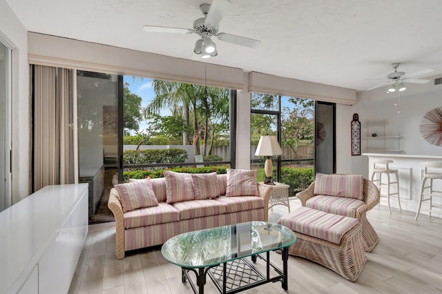 sunroom featuring visible vents and ceiling fan