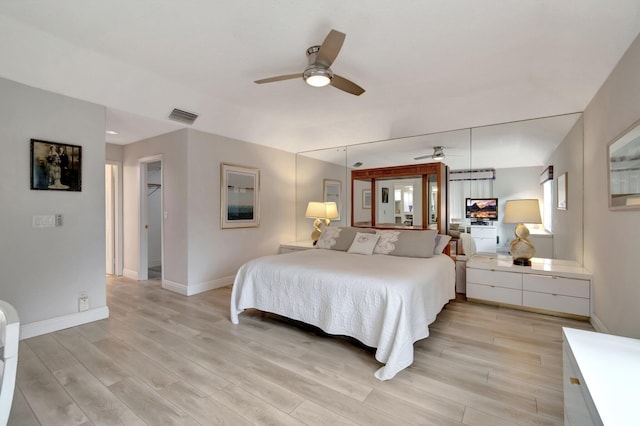 bedroom with visible vents, baseboards, and light wood-style floors