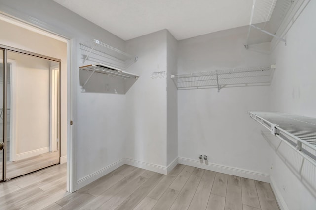 spacious closet with light wood finished floors