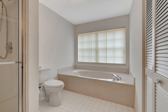 bathroom with a garden tub, toilet, a stall shower, a closet, and tile patterned flooring