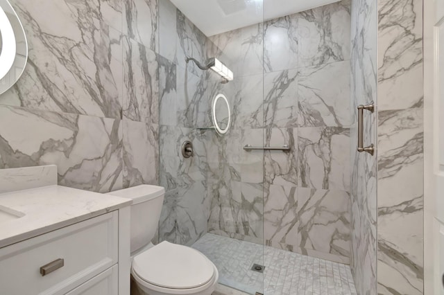 full bath with a marble finish shower, toilet, and vanity