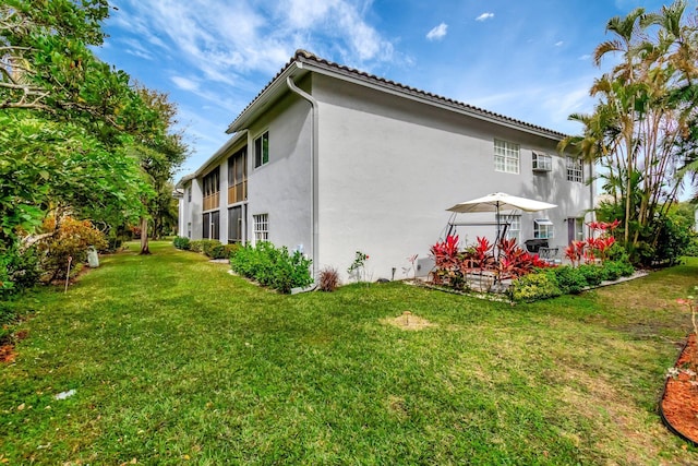 view of home's exterior featuring stucco siding and a yard