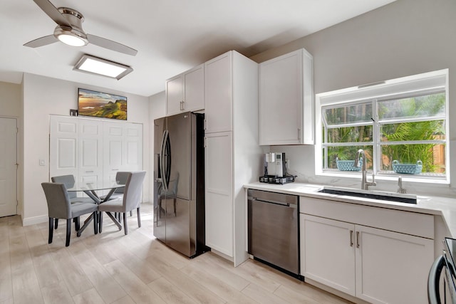 kitchen featuring a sink, black fridge with ice dispenser, stainless steel dishwasher, and light countertops