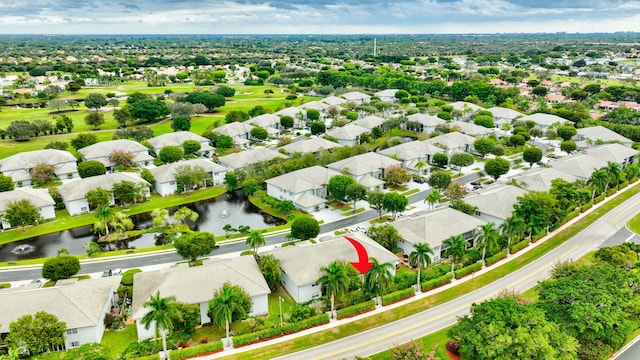 drone / aerial view with a residential view and a water view