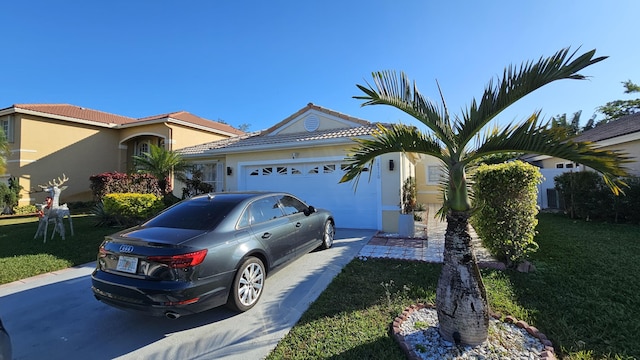 view of front of home featuring a front lawn and a garage