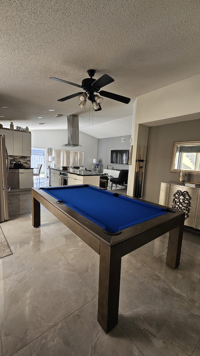 recreation room with pool table, ceiling fan, and a textured ceiling