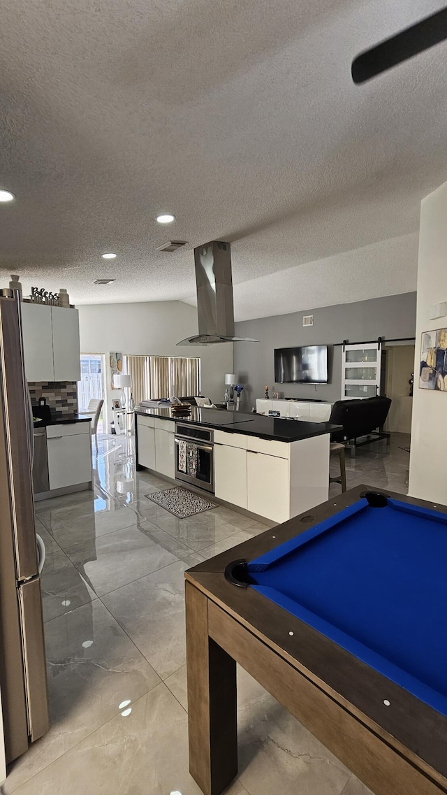 rec room with pool table and a textured ceiling