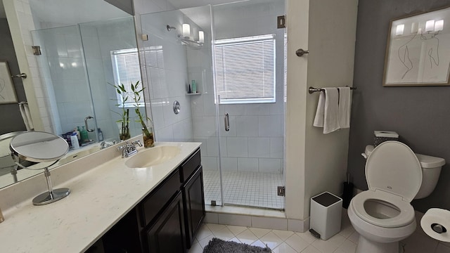 bathroom featuring vanity, tile patterned flooring, toilet, and walk in shower