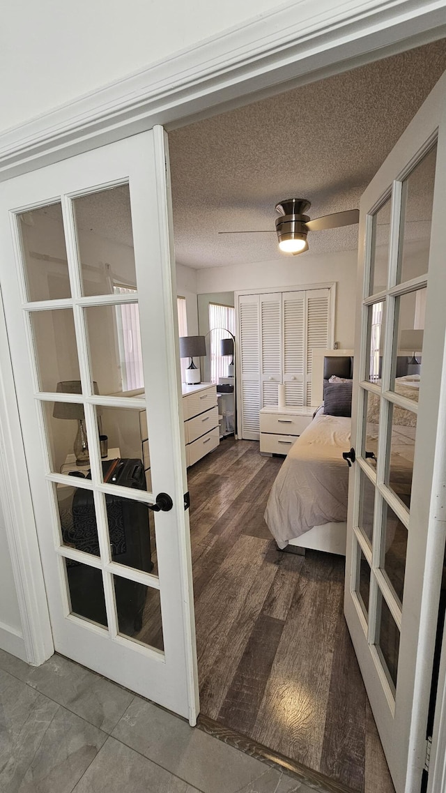 bedroom featuring a textured ceiling, french doors, and ceiling fan