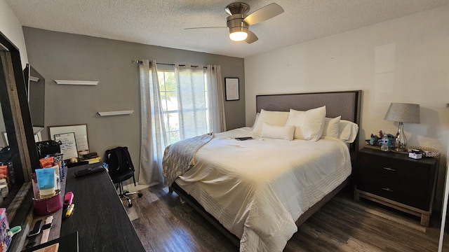 bedroom featuring a textured ceiling, ceiling fan, and dark hardwood / wood-style floors