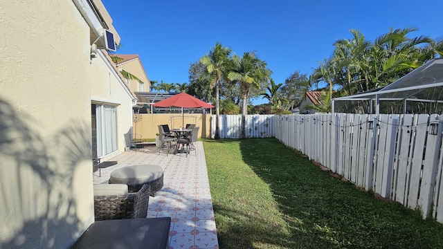 view of yard featuring a lanai and a patio