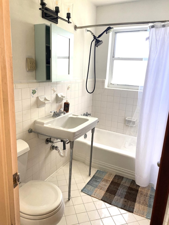 full bathroom with toilet, tile walls, tile patterned flooring, sink, and shower / bath combination with curtain