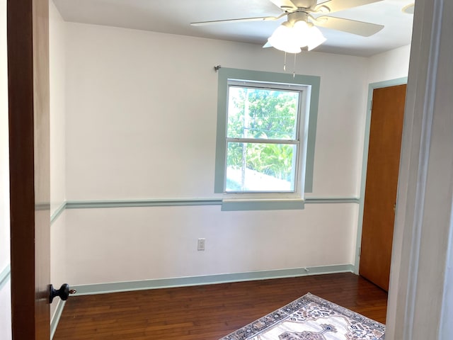 empty room with dark wood-type flooring and ceiling fan