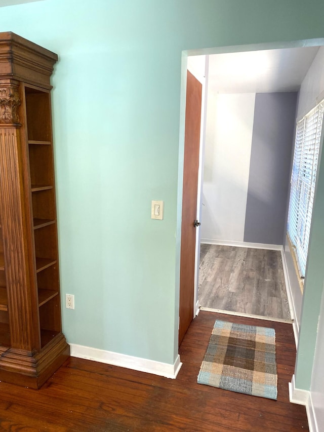 corridor featuring dark hardwood / wood-style flooring