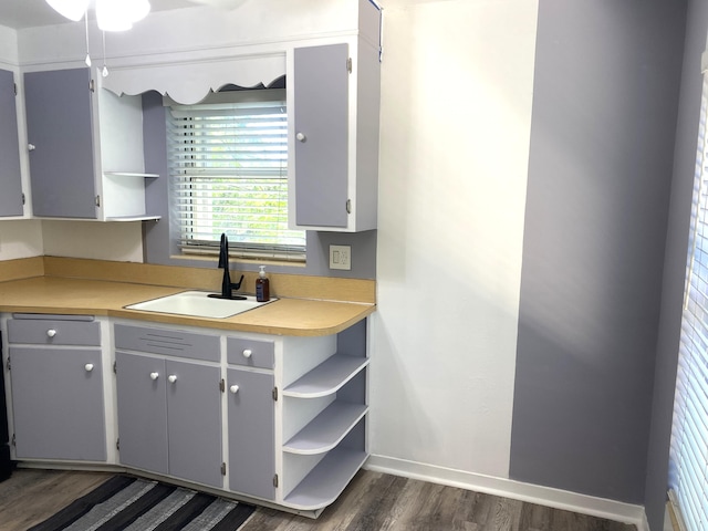 kitchen featuring dark wood-type flooring, gray cabinets, and sink